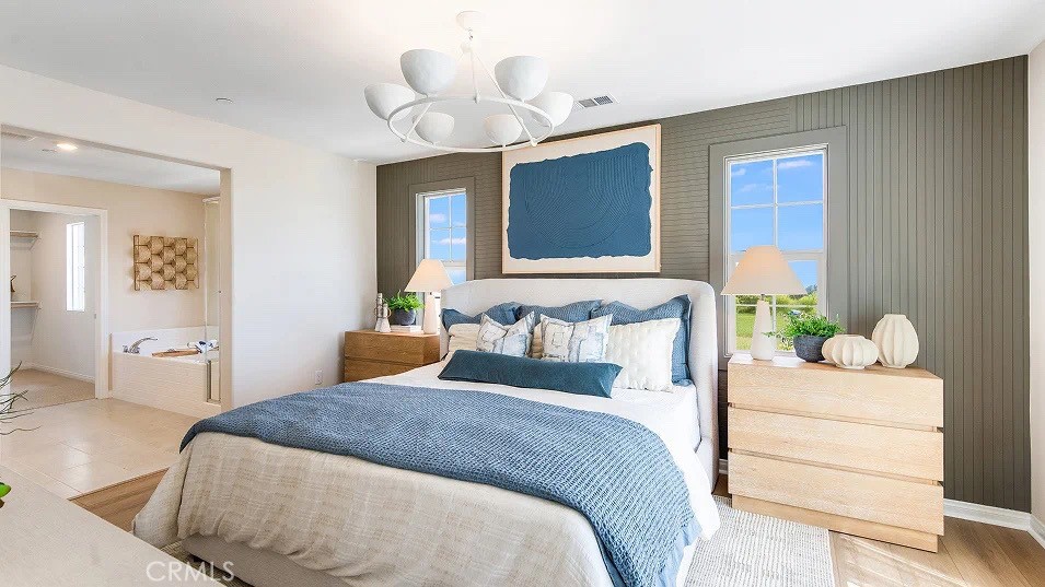 1700 Phantom Lane Rialto, CA 92376 - Photo 12 of 23 a bedroom with a large bed and a chandelier