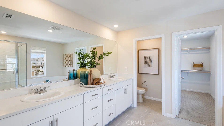 1700 Phantom Lane Rialto, CA 92376 - Photo 13 of 23 a en suite bathroom with double sink and a mirror