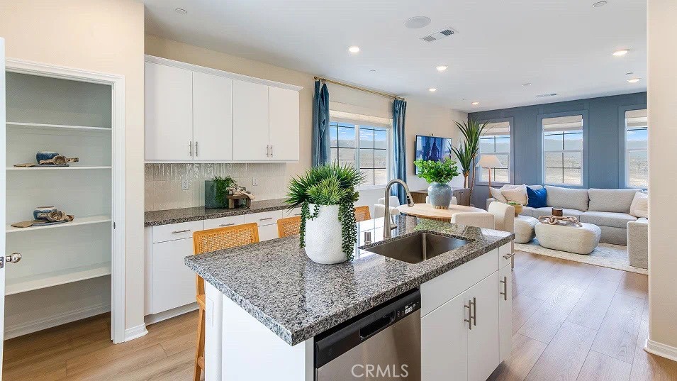 1700 Phantom Lane Rialto, CA 92376 - Photo 2 of 23 a kitchen with granite countertop a sink a counter top space and living room