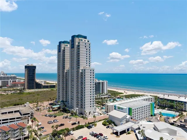 a view of a terrace with lawn chairs