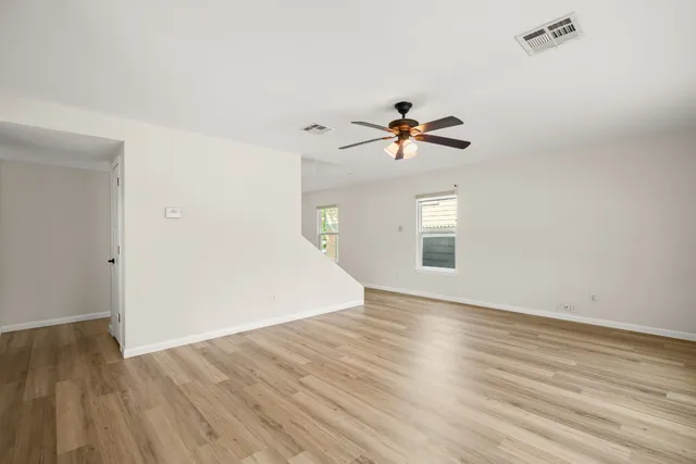 wooden floor in an empty room with a window