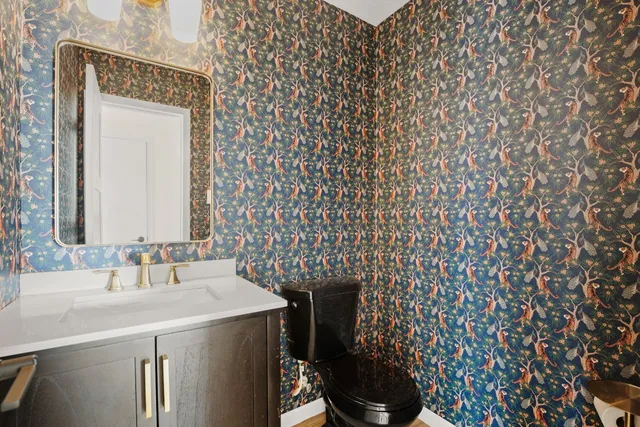 a bathroom with a sink a toilet and a mirror