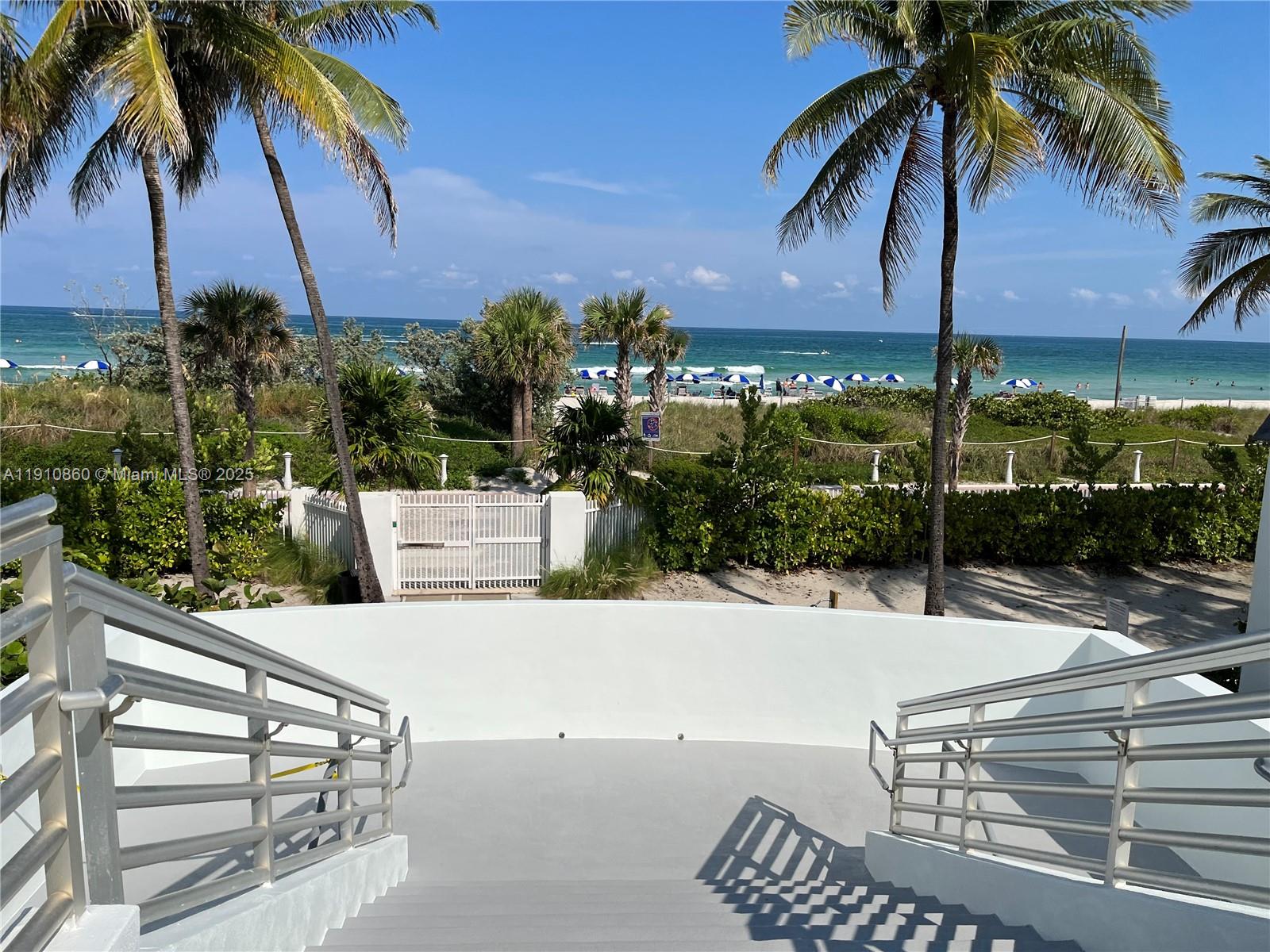 5161 Collins Avenue, Unit 214 Miami Beach, FL 33140 - Photo 1 of 13 a view of a patio with a table and chairs under an umbrella