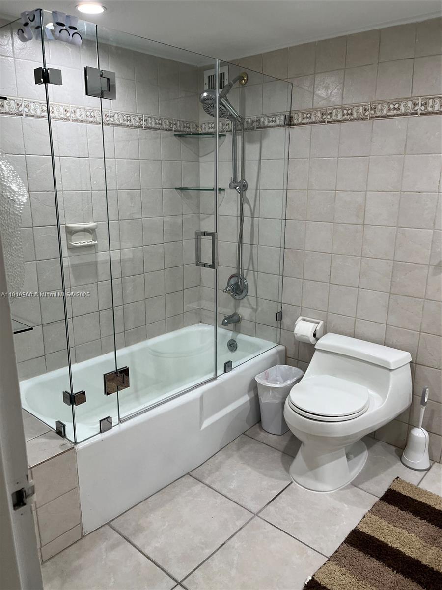 5161 Collins Avenue, Unit 214 Miami Beach, FL 33140 - Photo 12 of 13 a bathroom with a toilet a sink and bathtub