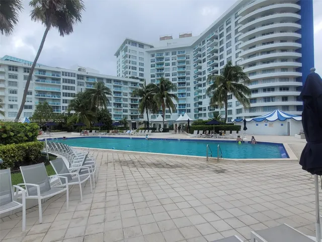 a view of a swimming pool with outdoor seating