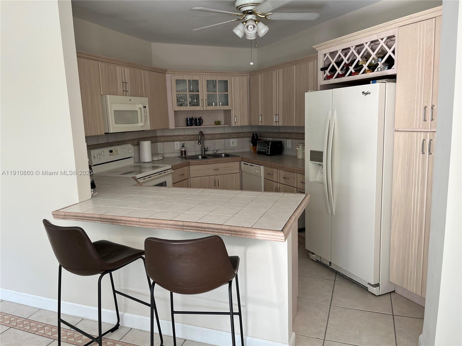 5161 Collins Avenue, Unit 214 Miami Beach, FL 33140 - Photo 5 of 13 a kitchen with stainless steel appliances a refrigerator and a refrigerator