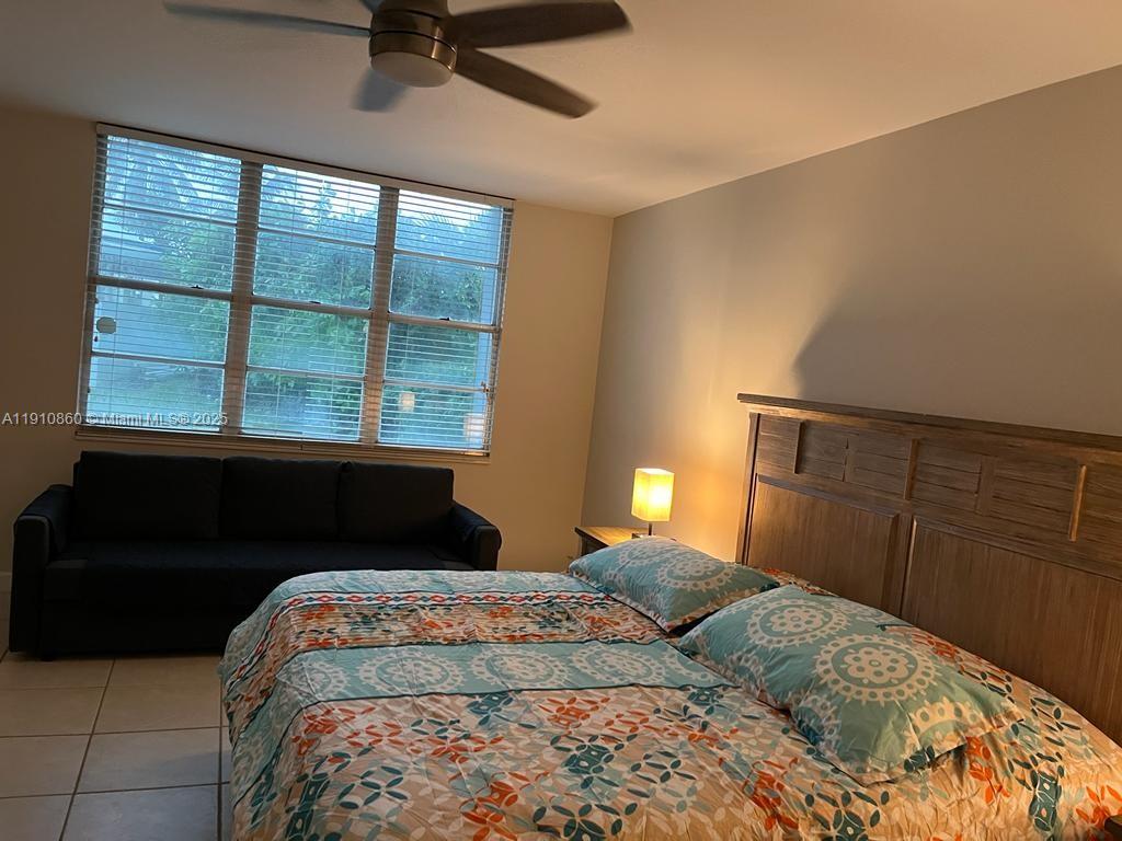 5161 Collins Avenue, Unit 214 Miami Beach, FL 33140 - Photo 7 of 13 a bedroom with a bed and a window