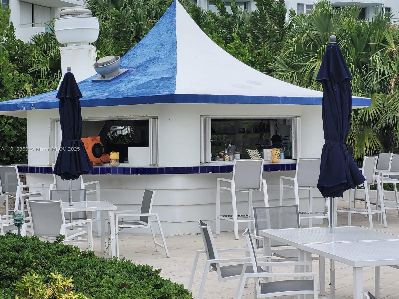 5161 Collins Avenue, Unit 214 Miami Beach, FL 33140 - Photo 9 of 13 a view of outdoor kitchen with seating area