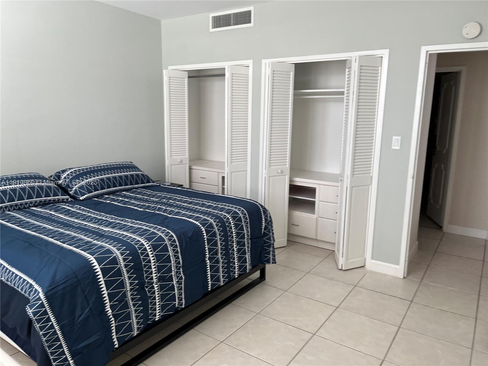 5161 Collins Avenue, Unit 214 Miami Beach, FL 33140 - Photo 10 of 13 a bedroom with a bed and a closet