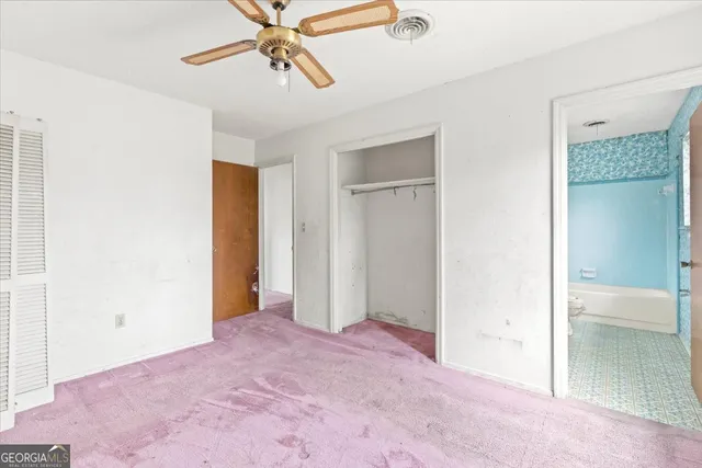 a view of a room with a ceiling fan