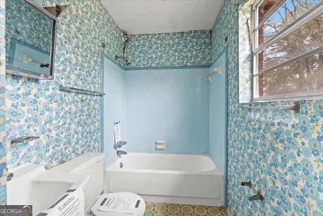 a bathroom with a bathtub and shower