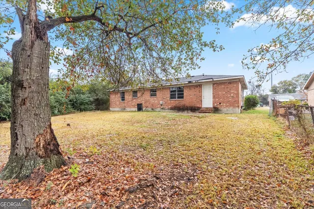 a house view with swimming pool in front of it