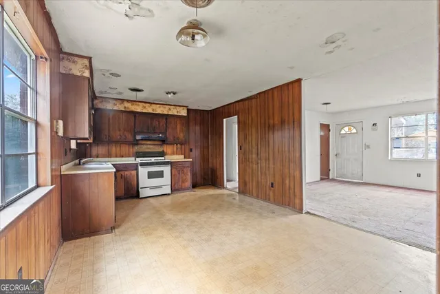 a view of kitchen with stainless steel appliances cabinets