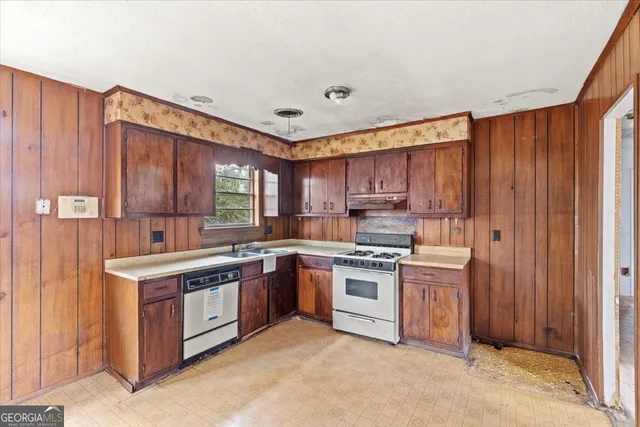 a kitchen with a stove top oven sink and cabinets