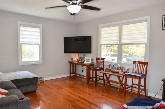 a view of a livingroom with furniture and a window