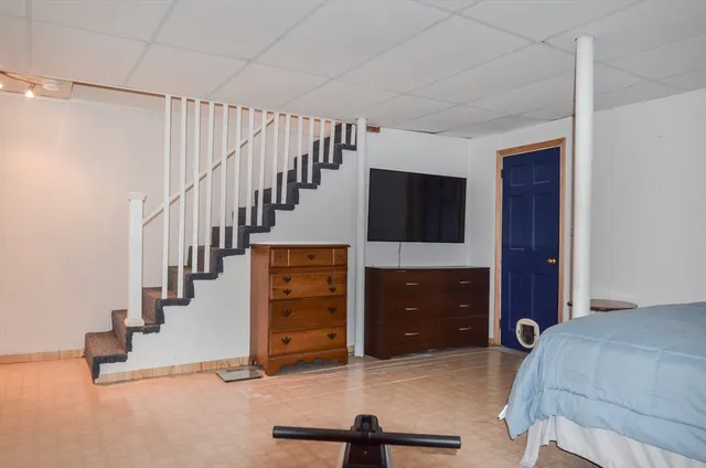 a living room with stairs and furniture