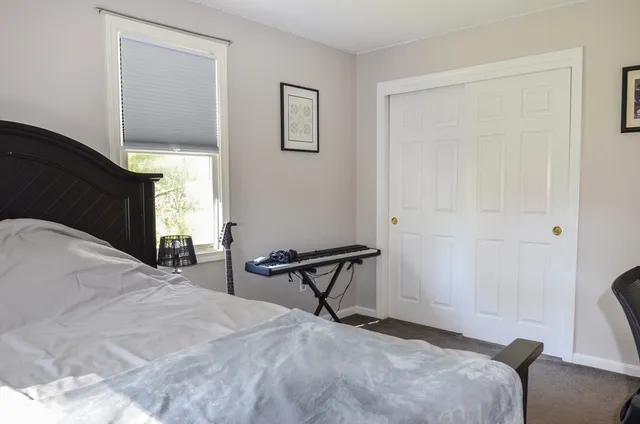 a bedroom with a bed and chair