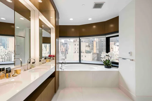 a bathroom with a sink double vanity and a mirror