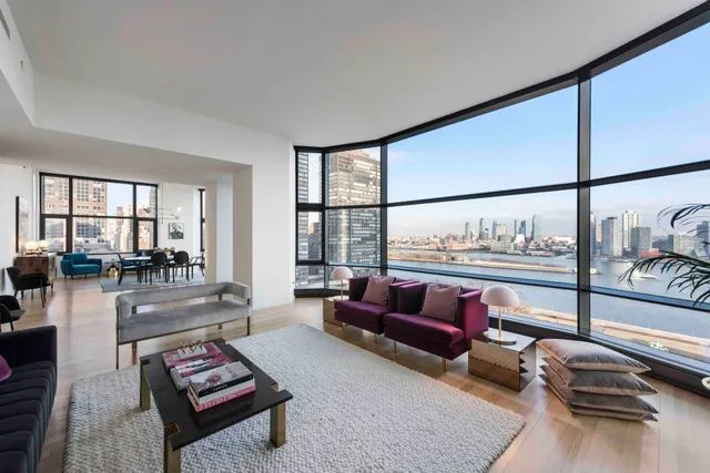 a living room with furniture and a floor to ceiling window