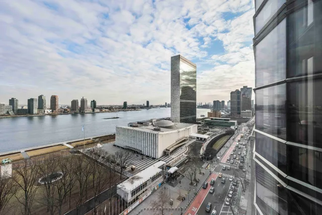 a view of a dining room with furniture large windows and wooden floor