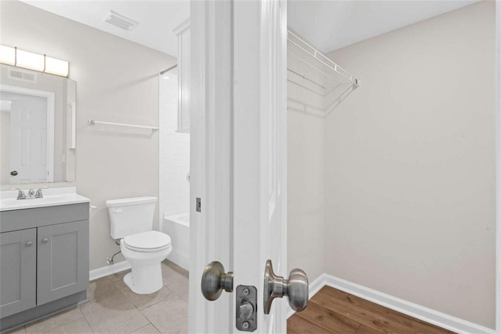 1166 Booth Road, Unit 407 Marietta, GA 30008 - Photo 15 of 18 a bathroom with a sink a toilet and shower