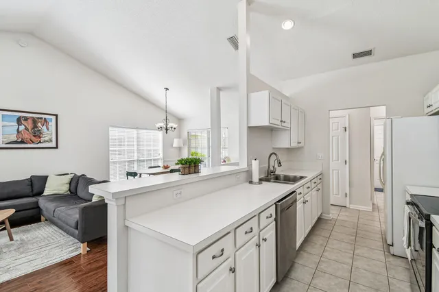 a kitchen with a sink stove and cabinets