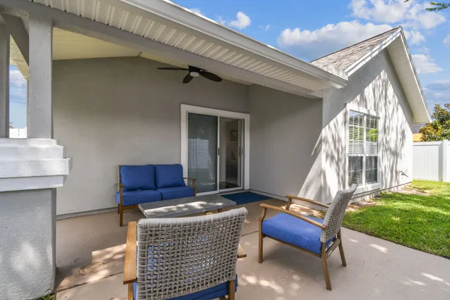 a building outdoor space with patio furniture and garden