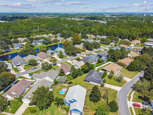 an aerial view of residential houses with outdoor space
