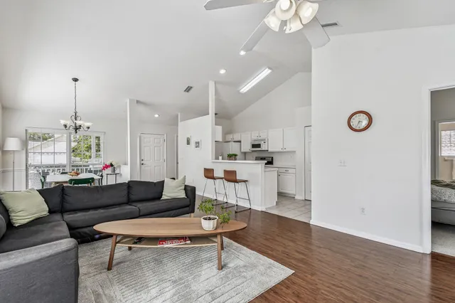 a living room with furniture and a wooden floor
