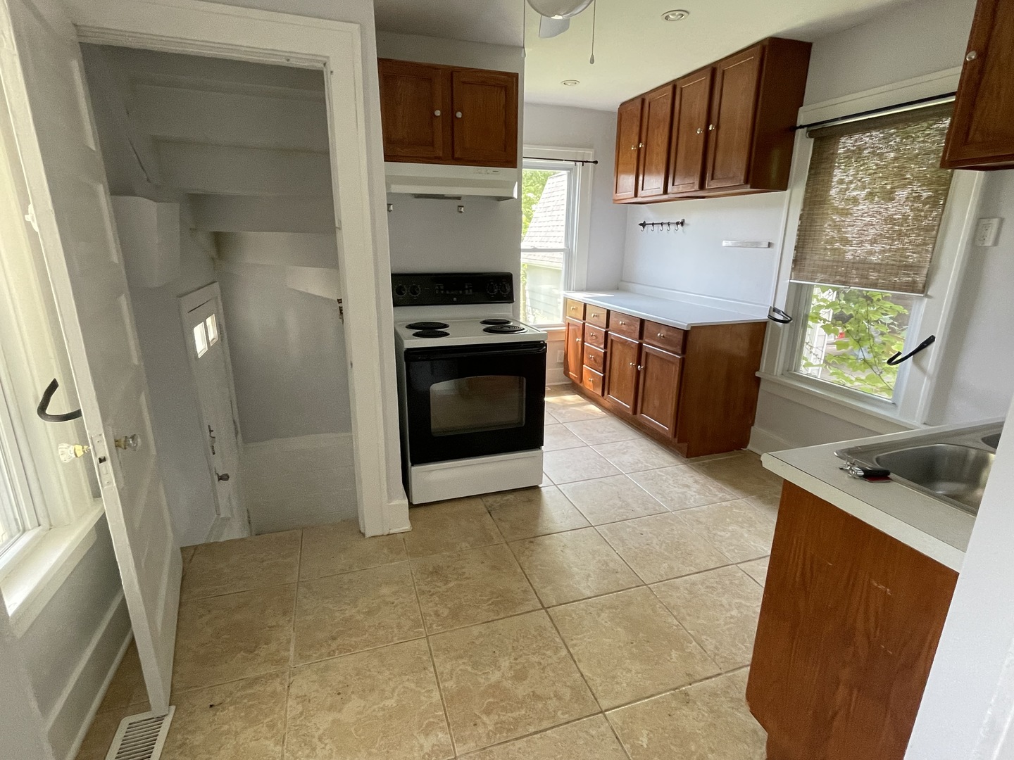 308 South Washington Street Wheaton, IL 60187 - Photo 13 of 27 a kitchen with stainless steel appliances a stove a refrigerator a sink a counter top space and cabinets