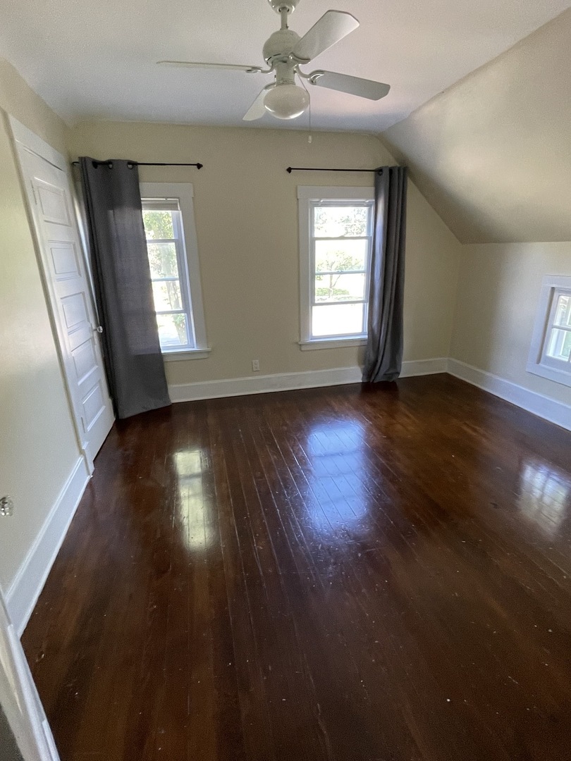 308 South Washington Street Wheaton, IL 60187 - Photo 20 of 27 an empty room with wooden floor and windows
