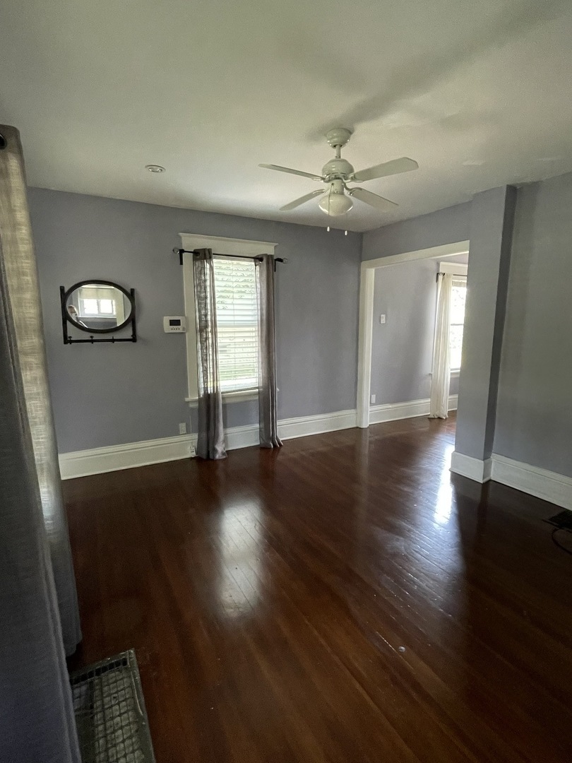 308 South Washington Street Wheaton, IL 60187 - Photo 8 of 27 an empty room with wooden floor and windows