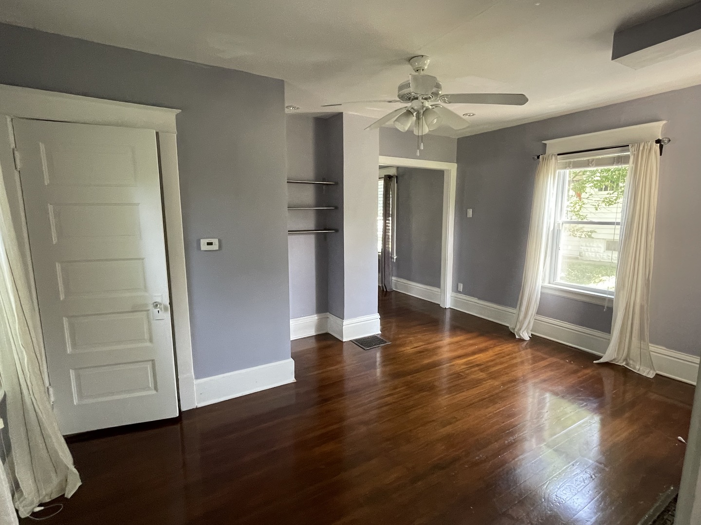 308 South Washington Street Wheaton, IL 60187 - Photo 10 of 27 an empty room with wooden floor chandelier and windows