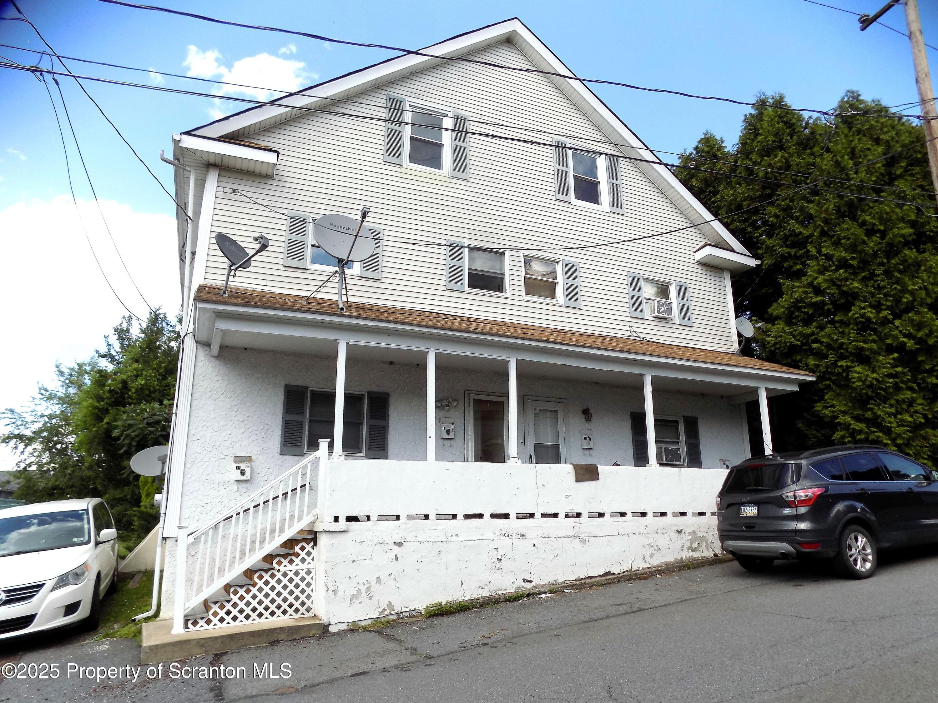 a view of a white house with a large space