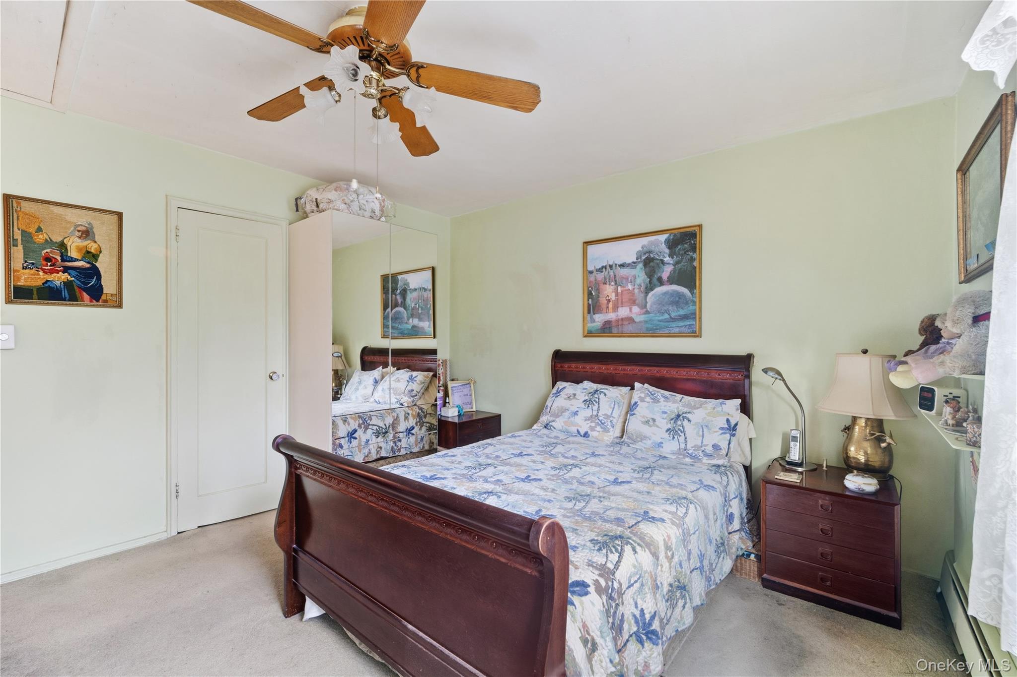 220-47 73rd Avenue, Unit UPPR Queens, NY 11364 - Photo 15 of 19 Carpeted bedroom with baseboard heating and ceiling fan