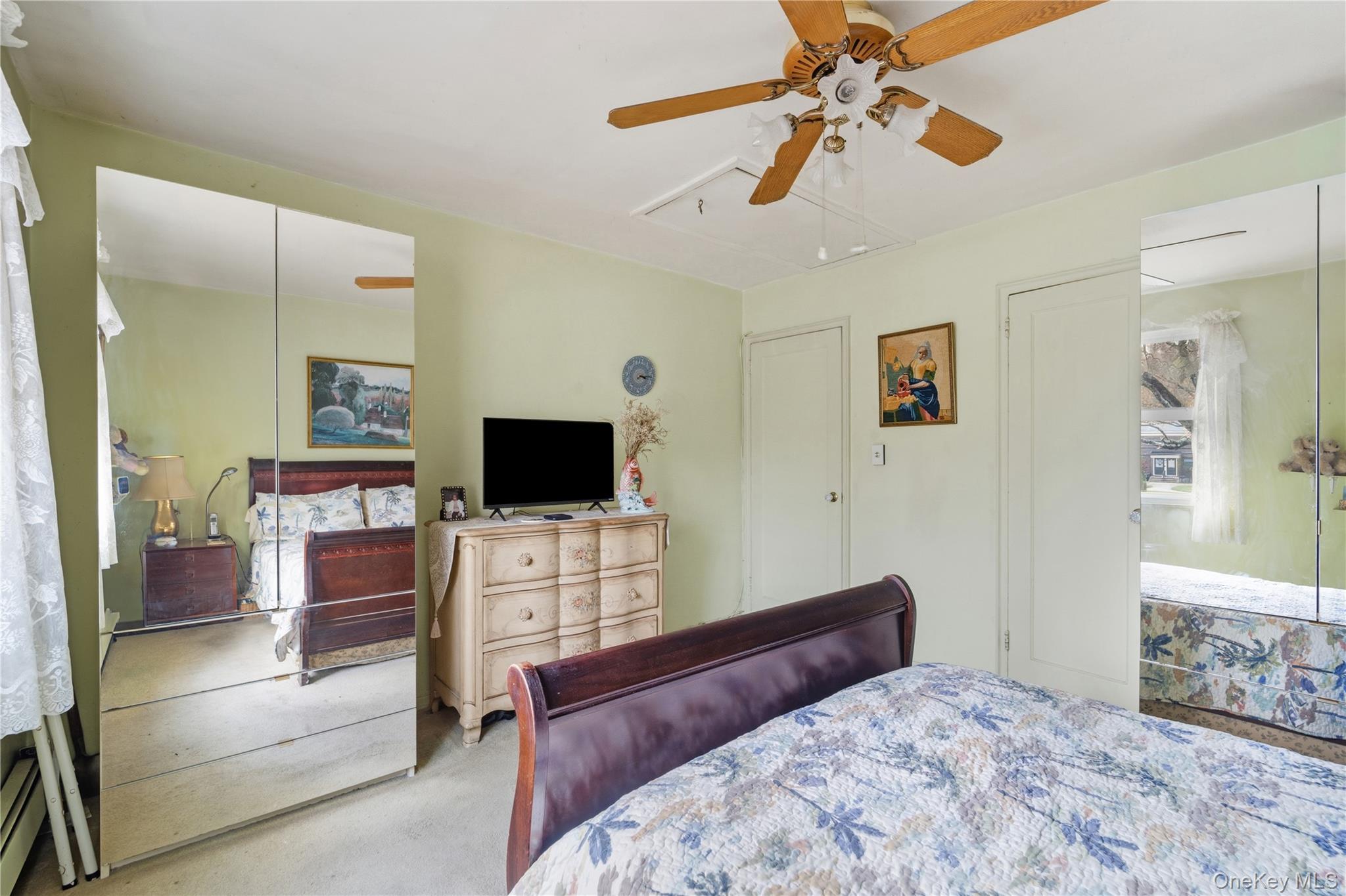 220-47 73rd Avenue, Unit UPPR Queens, NY 11364 - Photo 16 of 19 Carpeted bedroom featuring attic access and ceiling fan