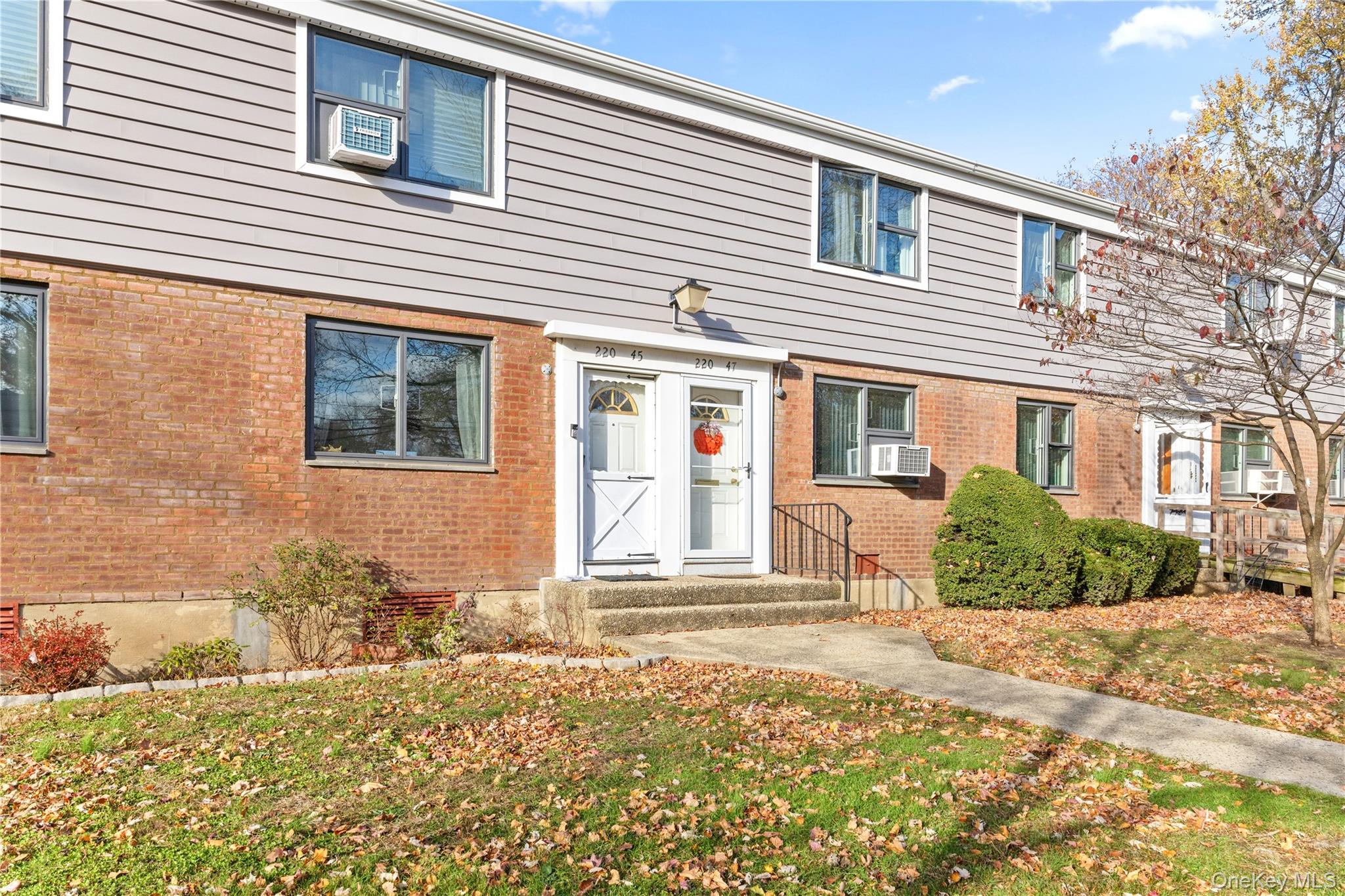 220-47 73rd Avenue, Unit UPPR Queens, NY 11364 - Photo 2 of 19 Colonial inspired home with brick siding and a front lawn