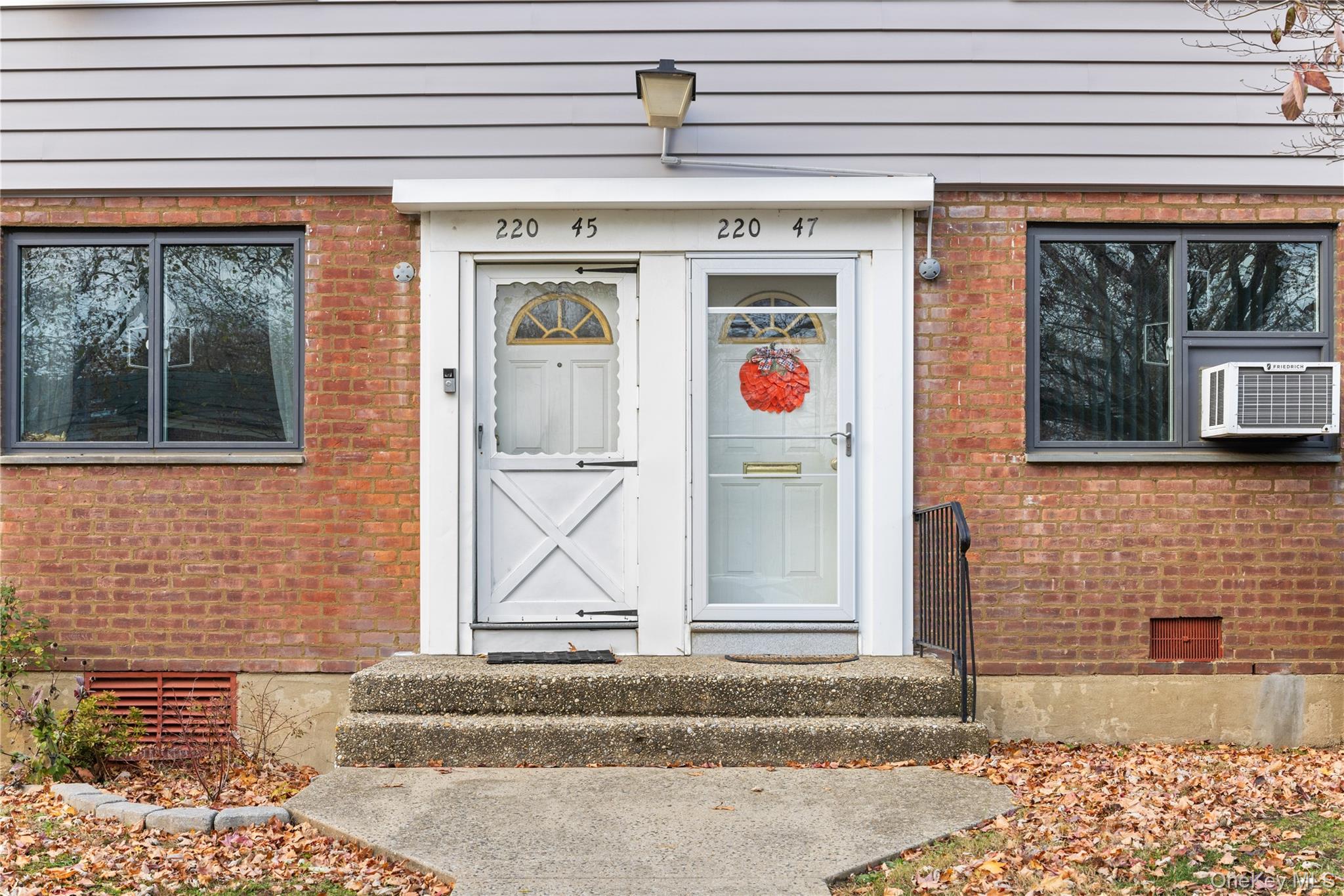 220-47 73rd Avenue, Unit UPPR Queens, NY 11364 - Photo 3 of 19 Entrance to property with brick siding, crawl space, and cooling unit