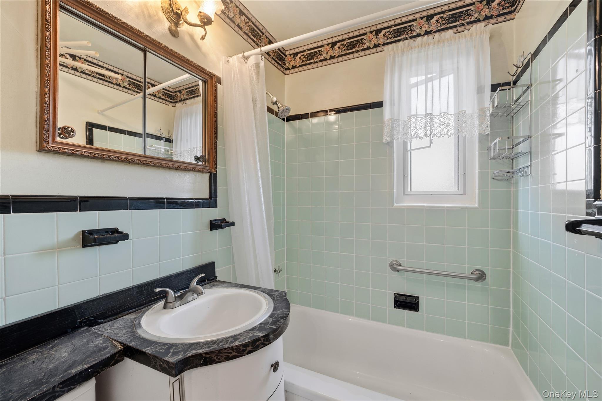 220-47 73rd Avenue, Unit UPPR Queens, NY 11364 - Photo 10 of 19 Bathroom with vanity, shower / bath combo with shower curtain, tile walls, and backsplash