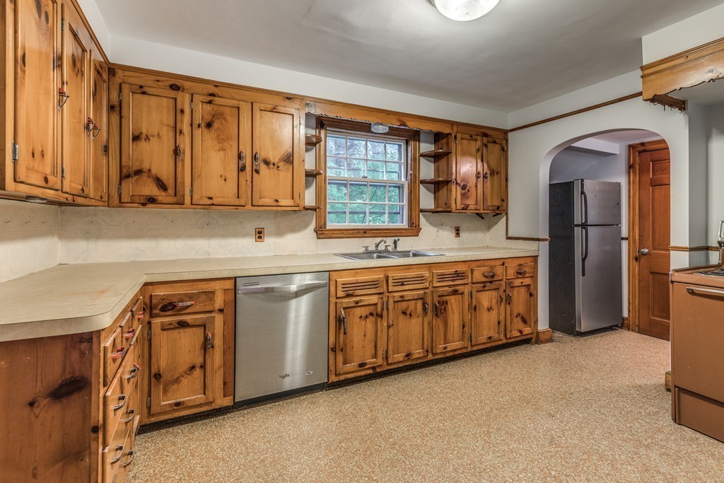 24 Gordon Road Milton, MA 02186 - Photo 16 of 30 a kitchen with stainless steel appliances granite countertop a stove a sink and a refrigerator with cabinets