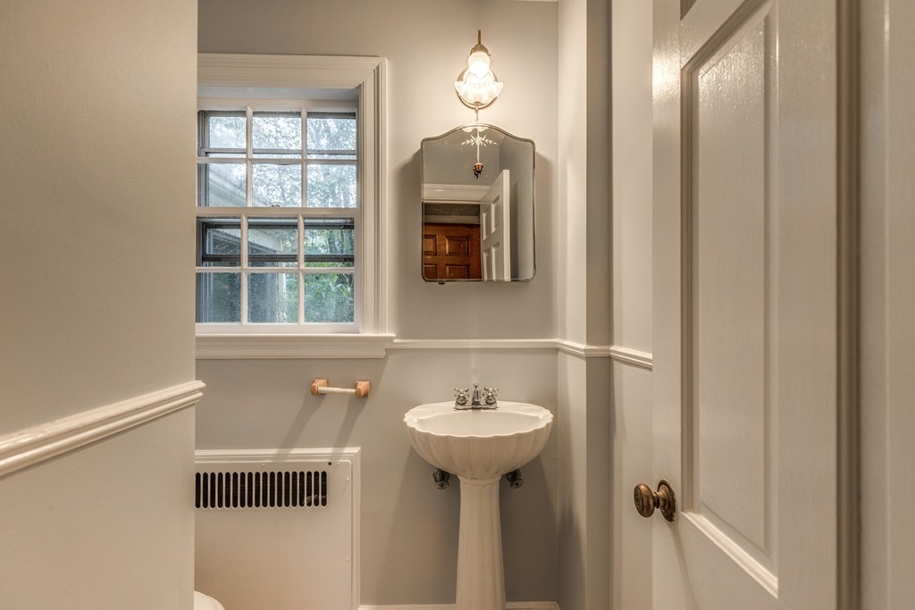 24 Gordon Road Milton, MA 02186 - Photo 18 of 30 a bathroom with a sink and a mirror