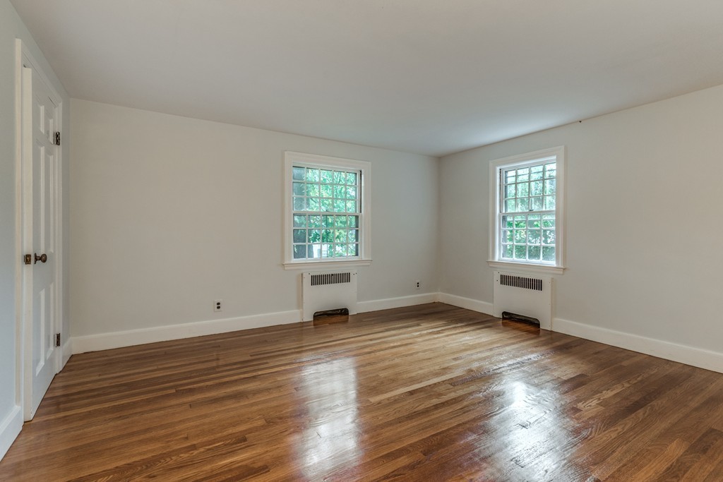 24 Gordon Road Milton, MA 02186 - Photo 22 of 30 an empty room with wooden floor and windows