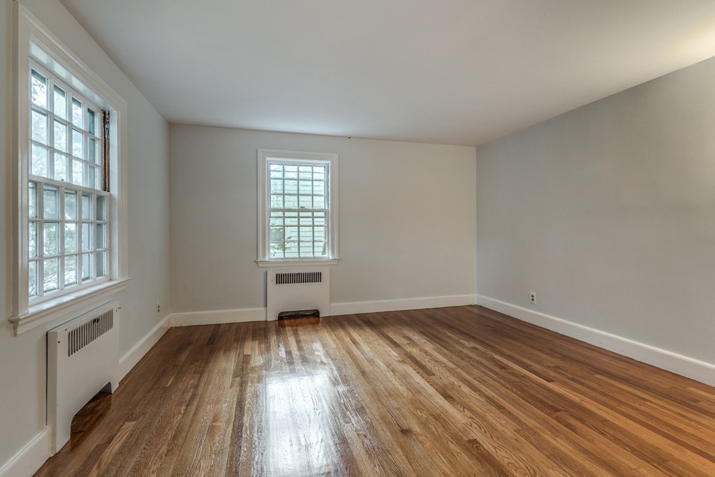 24 Gordon Road Milton, MA 02186 - Photo 23 of 30 an empty room with wooden floor and windows