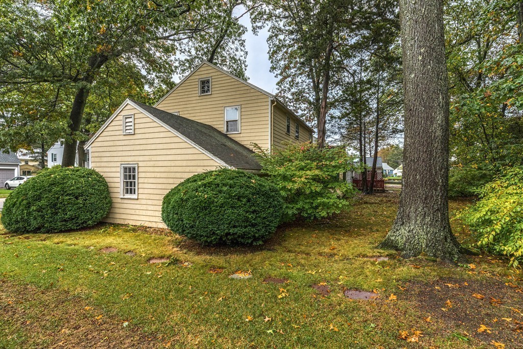24 Gordon Road Milton, MA 02186 - Photo 26 of 30 a view of a house with a yard and large tree