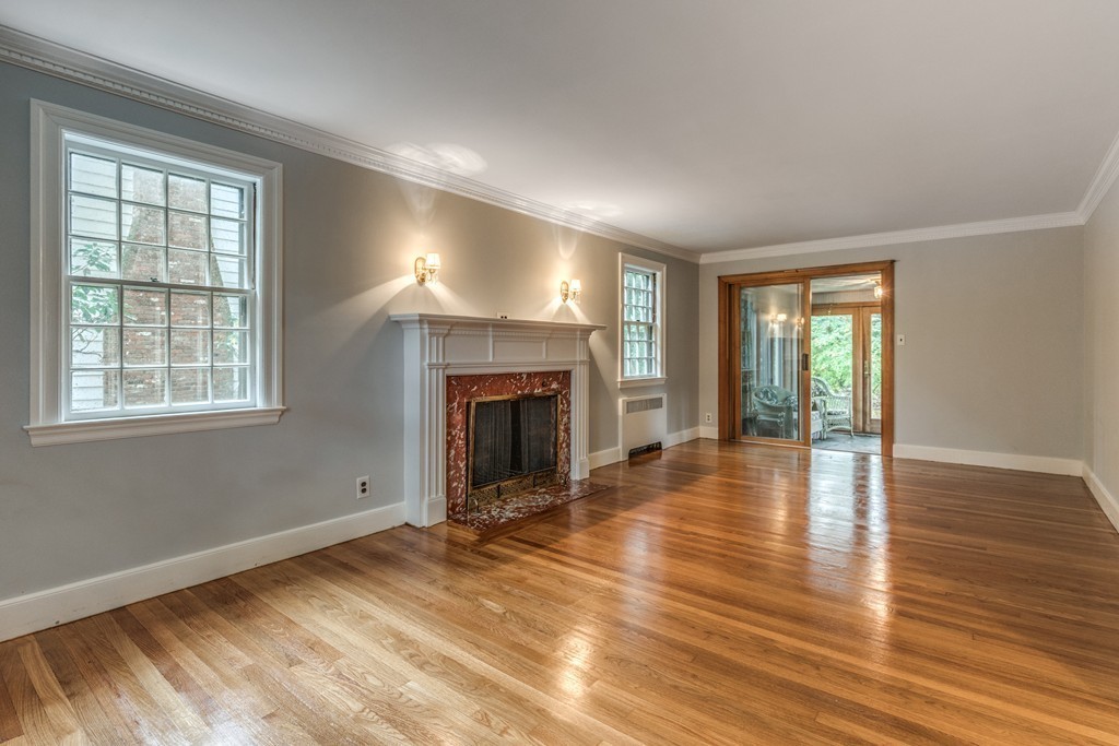 24 Gordon Road Milton, MA 02186 - Photo 9 of 30 an empty room with wooden floor and fireplace