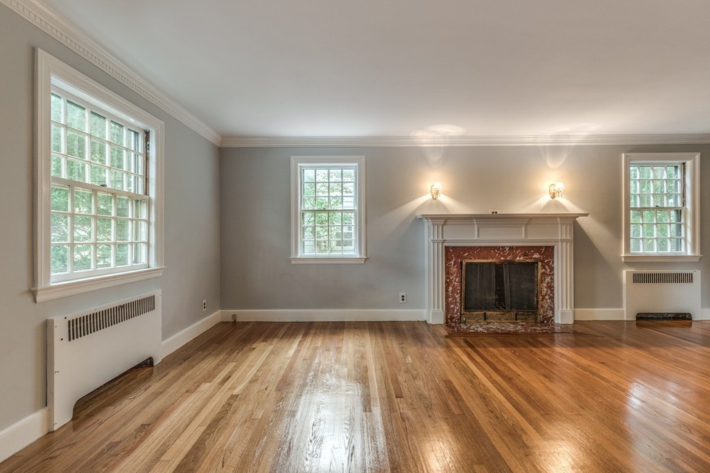 24 Gordon Road Milton, MA 02186 - Photo 10 of 30 wooden floor fireplace and windows in an empty room