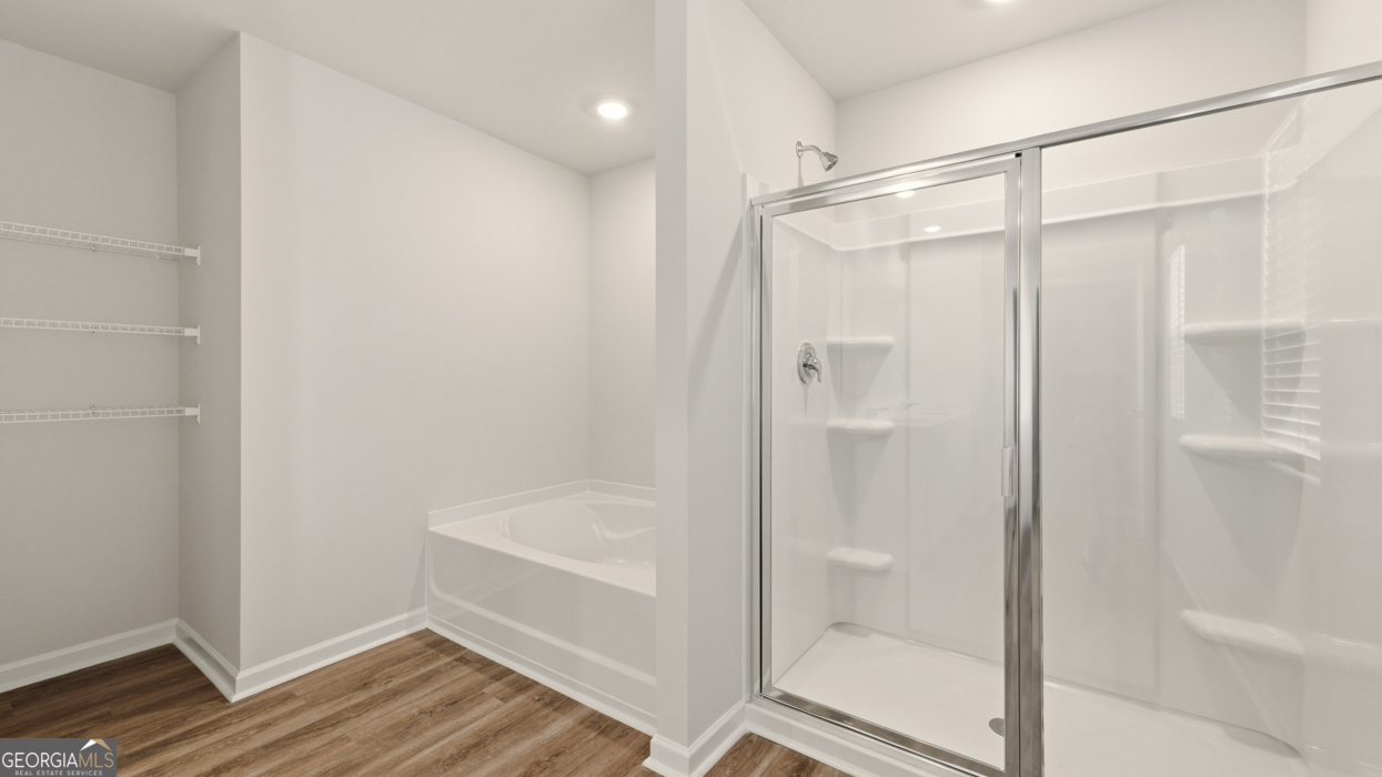 8578 Seabiscuit Road Lithonia, GA 30058 - Photo 25 of 30 a bathroom with a bathtub and a shower