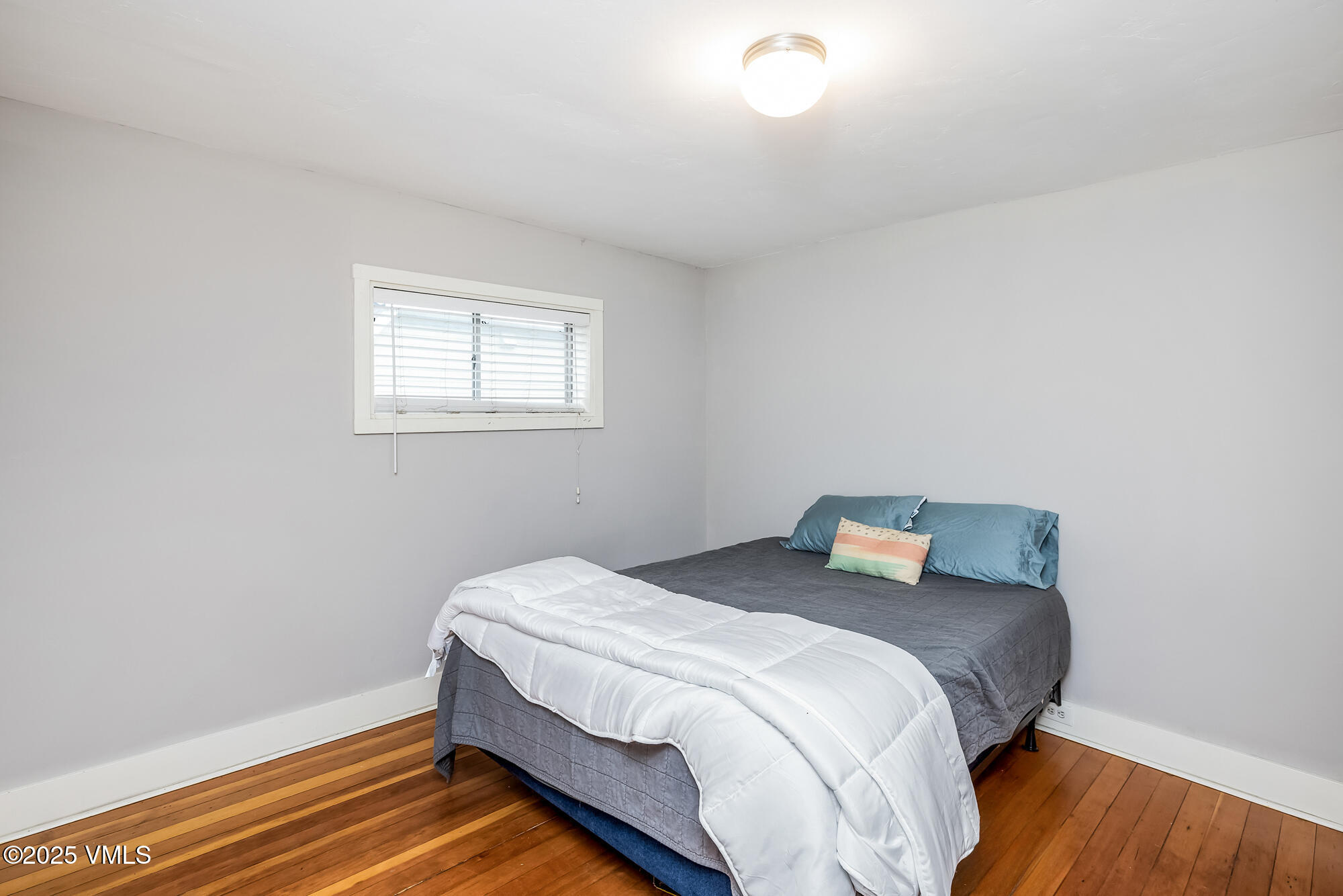 246 Capitol Street Eagle, CO 81631 - Photo 19 of 31 a bedroom with a bed and wooden floor