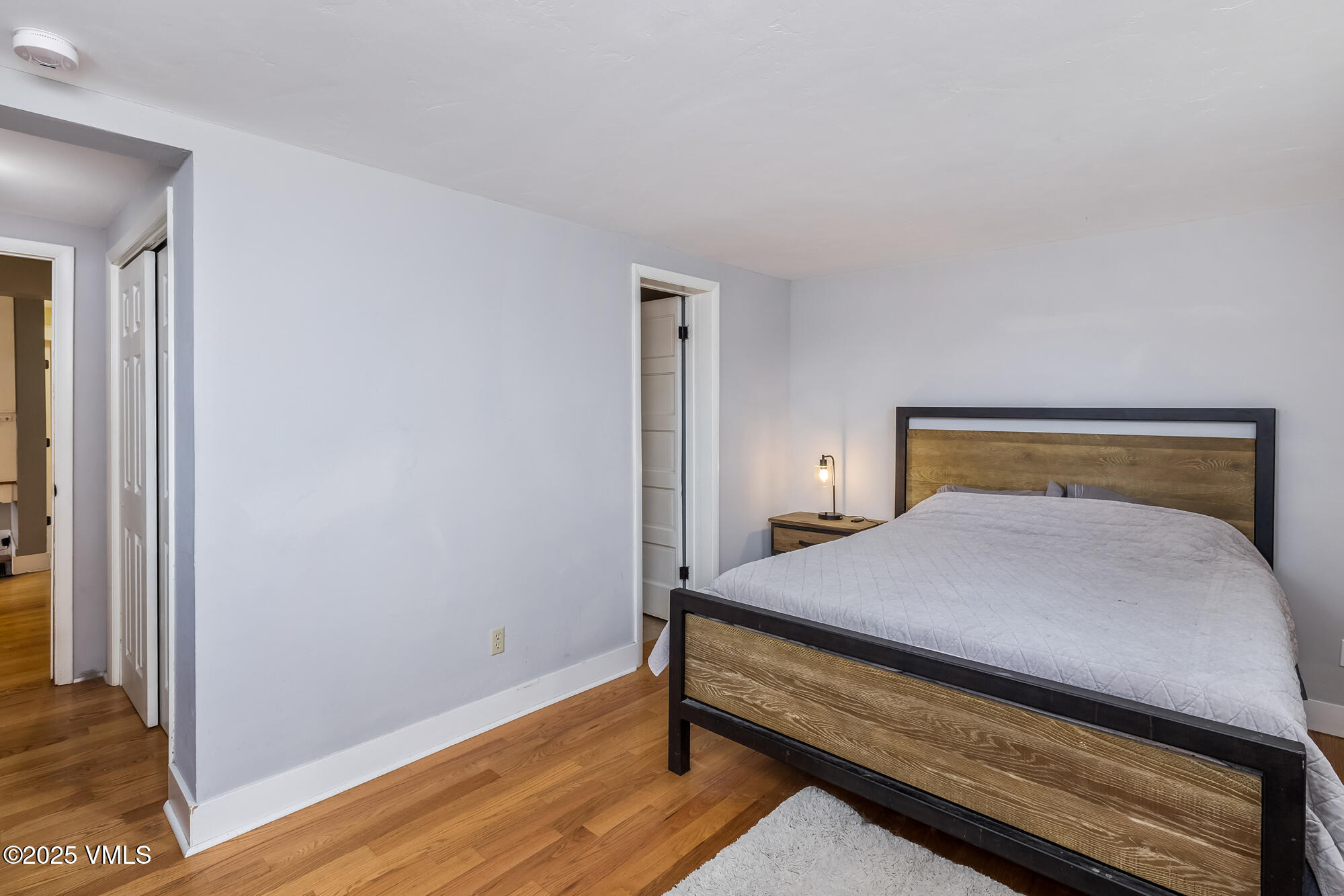 246 Capitol Street Eagle, CO 81631 - Photo 23 of 31 a bedroom with a bed and wooden floor