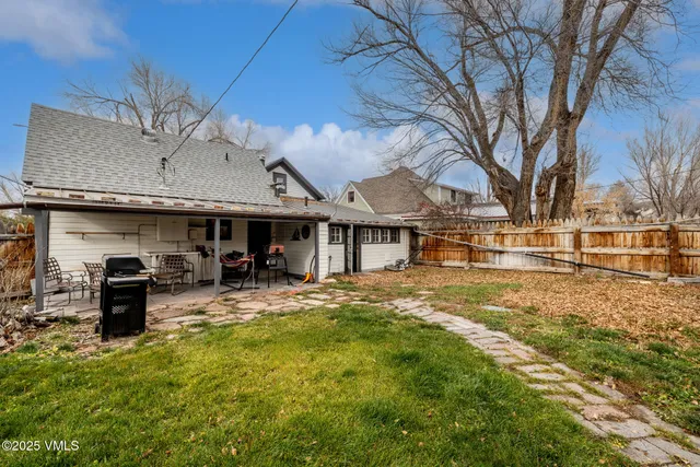 a view of a house with a yard and garage